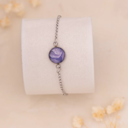 Dar Suad bracelet featuring marbling artwork in purple and white with a stainless steel setting.