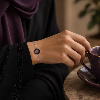 Model wearing Dar Suad stainless steel bracelet featuring abstract artwork in black, silver, and red.