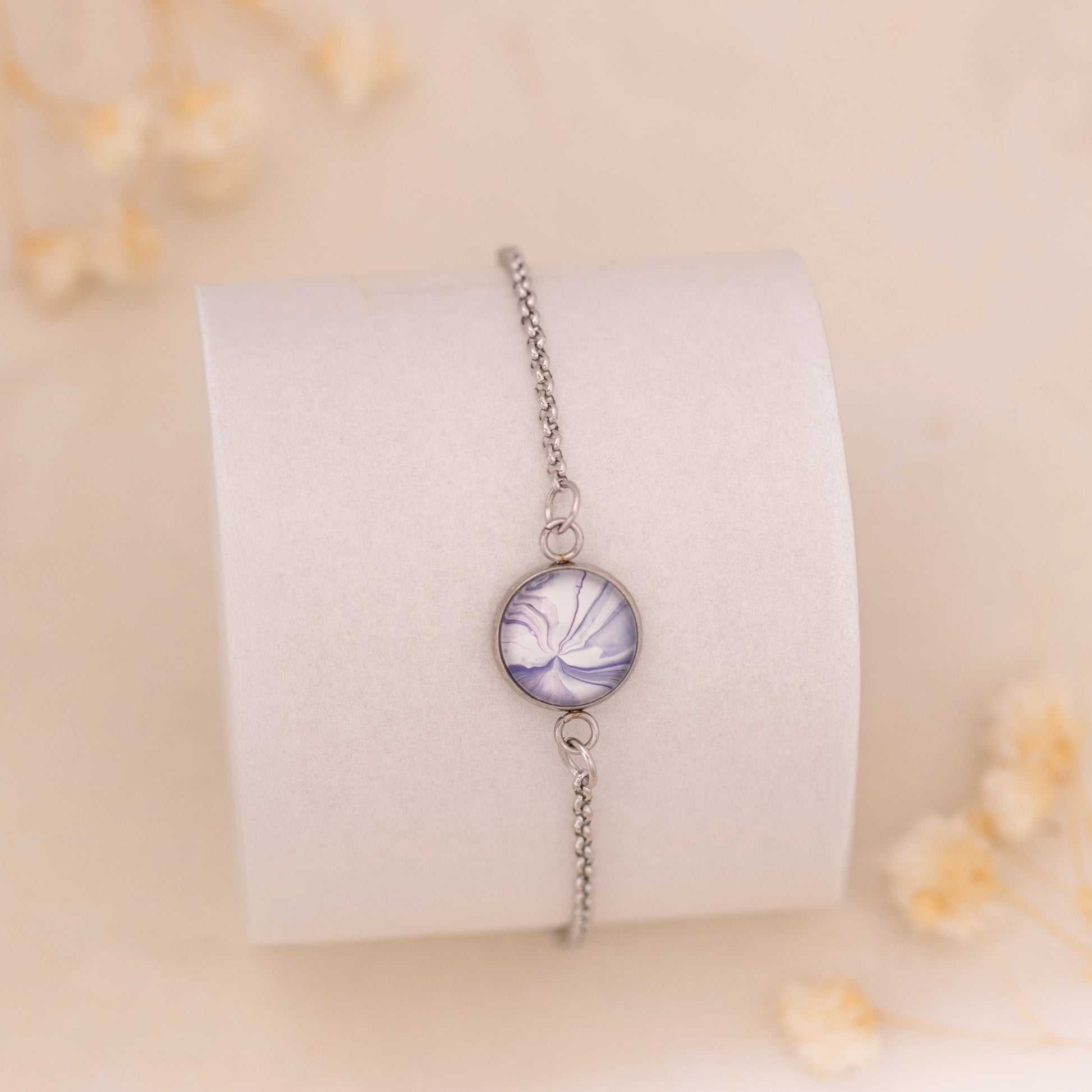Dar Suad bracelet featuring marbling artwork in purple and white with a stainless steel setting.