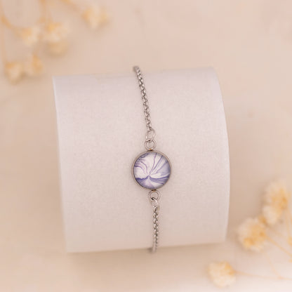 Dar Suad bracelet featuring marbling artwork in purple and white with a stainless steel setting.