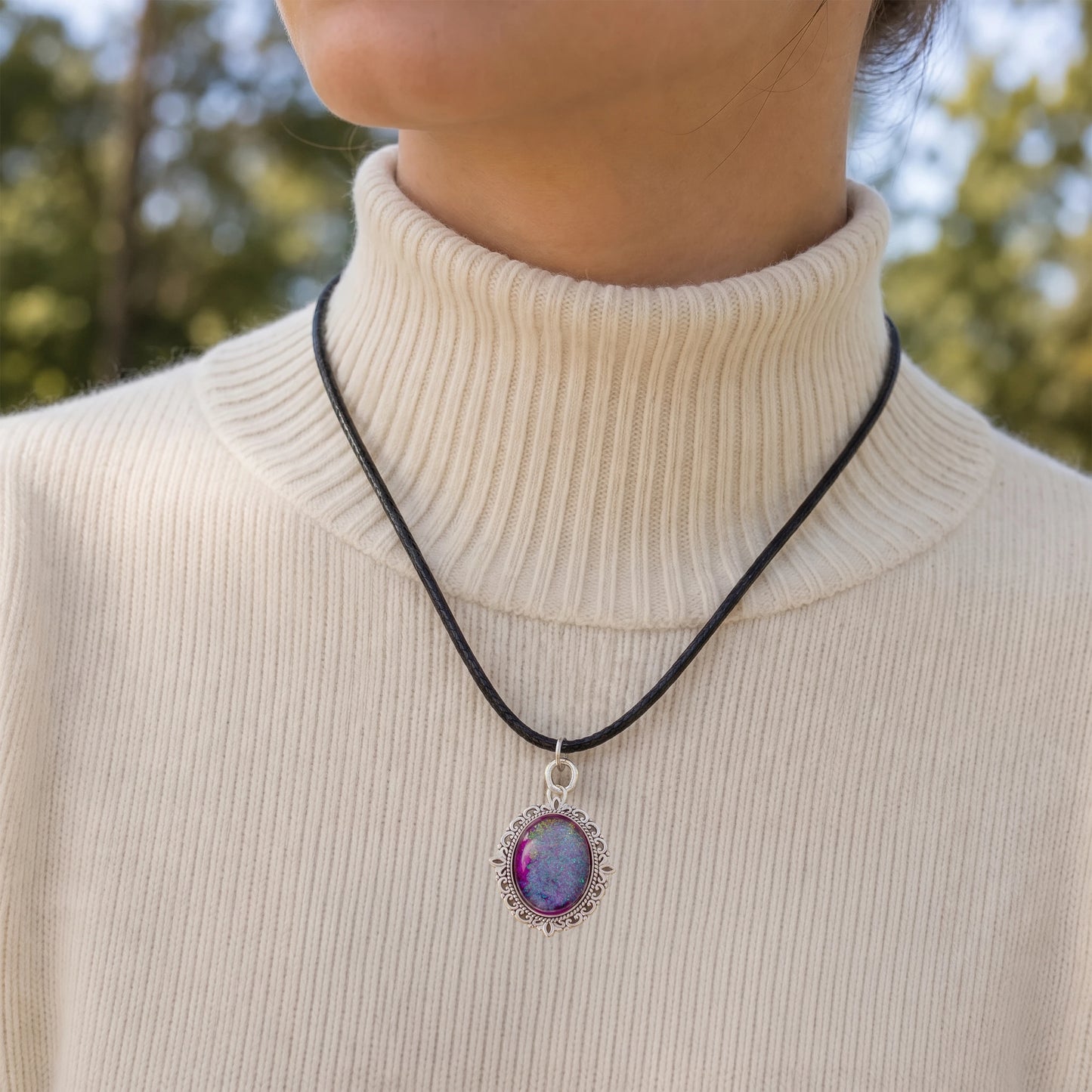 Model wearing a Dar Suad alloy necklace featuring one-of-a-kind artwork in purple.
