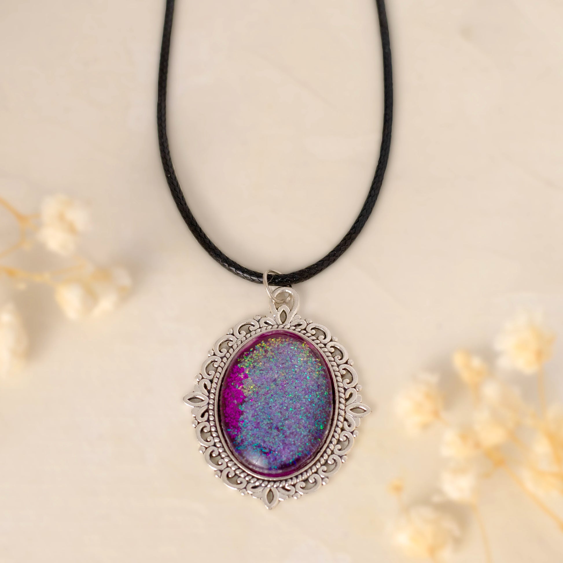 Dar Suad necklace featuring one-of-a-kind artwork in purple with an alloy setting.
