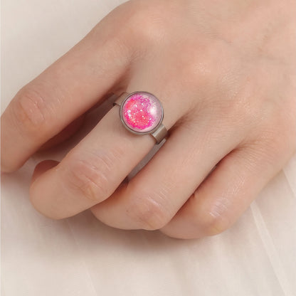 Model wearing Dar Suad stainless steel ring featuring one-of-a-kind original artwork in pink and white.