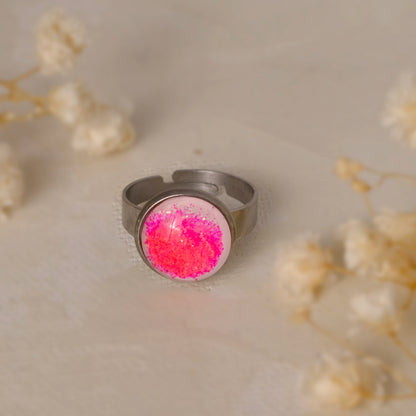 Dar Suad ring featuring one-of-a-kind original artwork in pink and white with a stainless steel setting.