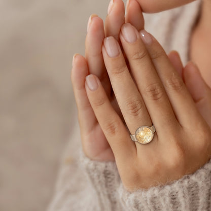 Model wearing Dar Suad stainless steel ring featuring one-of-a-kind original artwork in gold and silver.