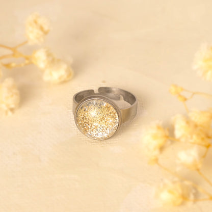Main image:
Dar Suad ring featuring one-of-a-kind original artwork in gold and silver with a stainless steel setting.
